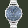 A silver-tone Tommy Hilfiger analog watch with a blue patterned dial and a matching silver-tone metal link bracelet, shown against a plain white background.