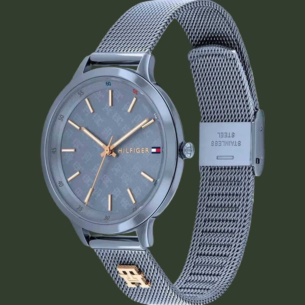 A Tommy Hilfiger women's stainless steel watch with a gray dial, gray mesh strap, and rose gold-tone hands and markers.