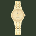 Gold watch with Tommy Hilfiger logo on a white background