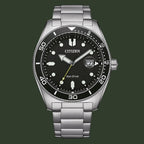 Citizen Eco-Drive stainless steel watch with a black dial, black rotating bezel, silver-tone case, and integrated link bracelet on a white background.