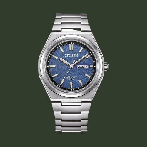 Citizen Eco-Drive stainless steel watch with a blue textured dial, silver-tone case, and integrated metal link bracelet on a white background.