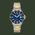 Two-tone watch with blue dial and gold accents on a white background