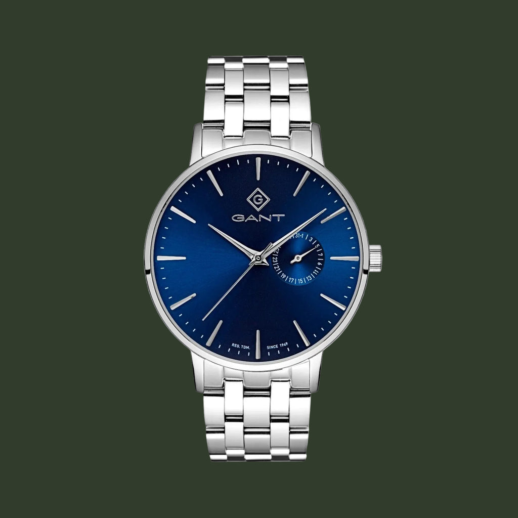 A GANT men's analog watch with a silver stainless steel link bracelet, a blue sunburst dial, and a small blue 24-hour subdial at the 3 o'clock position.