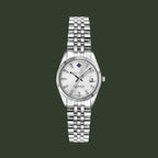 A silver-tone stainless steel watch with a fluted bezel, silver link bracelet, and a white dial featuring a date window and black hands.