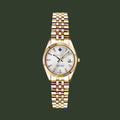 Gold wristwatch with a white dial on a white background