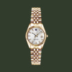 Gold wristwatch with a white dial on a white background