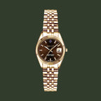 Gold wristwatch with a brown dial on a white background