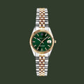 A GANT men's watch featuring a two-tone silver and gold stainless steel link bracelet, a fluted gold bezel, and a deep green dial with a date window.