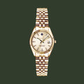 A GANT men's watch featuring a gold-tone metal bracelet, a fluted bezel, and a cream-colored dial with a date window.