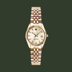 A GANT men's watch featuring a gold-tone metal bracelet, a fluted bezel, and a cream-colored dial with a date window.