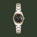 Two-tone watch with black dial and gold accents on a white background