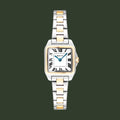 A Cartier watch with a square silver-tone case, gold-tone accents on the bezel, lugs, and bracelet links, and a white dial with black Roman numerals.