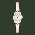 A women's analog watch with a rose gold metal bracelet, a fluted bezel, and a white dial with gold-tone hands and hour markers. The brand name 'G-LORAL' is visible on the dial.