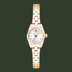 A women's analog watch with a rose gold metal bracelet, a fluted bezel, and a white dial with gold-tone hands and hour markers. The brand name 'G-LORAL' is visible on the dial.
