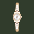 A women's rose gold watch with a matching metal link bracelet, featuring a white dial with small diamond hour markers and a bezel accented with clear crystals, shown against a plain white background.