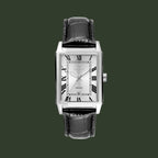 A Cartier wristwatch with a rectangular silver-tone case, a white dial with black Roman numerals, and a black alligator-textured leather strap, shown against a plain white background.