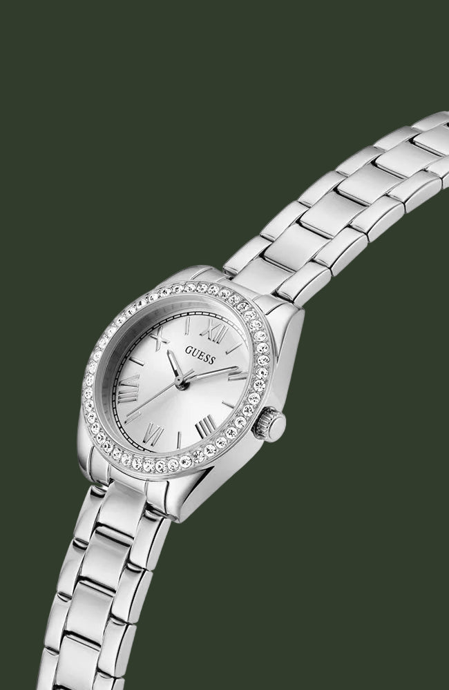 A silver-tone stainless steel wrist watch with a round bezel set with clear crystals, a white dial with Roman numerals, and a matching metal link bracelet, shown on a plain white background.