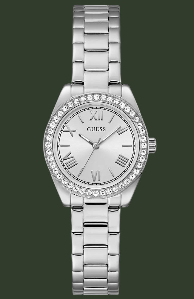 A silver-tone stainless steel wrist watch with a link bracelet, a crystal-studded bezel, and a white dial with Roman numerals. The brand name 'GUESS' is visible on the dial.