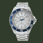 Seiko watch with silver bracelet and blue bezel on a white background