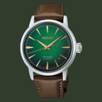 A Seiko Presage Automatic watch featuring a green dial, gold-tone hands and hour markers, and a brown leather strap, shown against a plain white background.