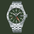 A Seiko Automatic GMT watch with a silver stainless steel link bracelet, a green dial, and a silver rotating bezel, shown on a plain white background.