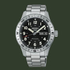 A Seiko automatic wristwatch with a silver stainless steel case and link bracelet, featuring a black dial with white Arabic numerals and a rotating bezel.