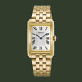 A Seiko women's watch featuring a gold-tone rectangular case, a white sunburst dial with black Roman numerals, and a matching gold-tone link bracelet.