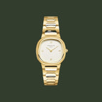 Gold watch with a white face on a light beige background