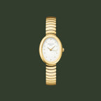 Gold watch with a white face on a light gray background