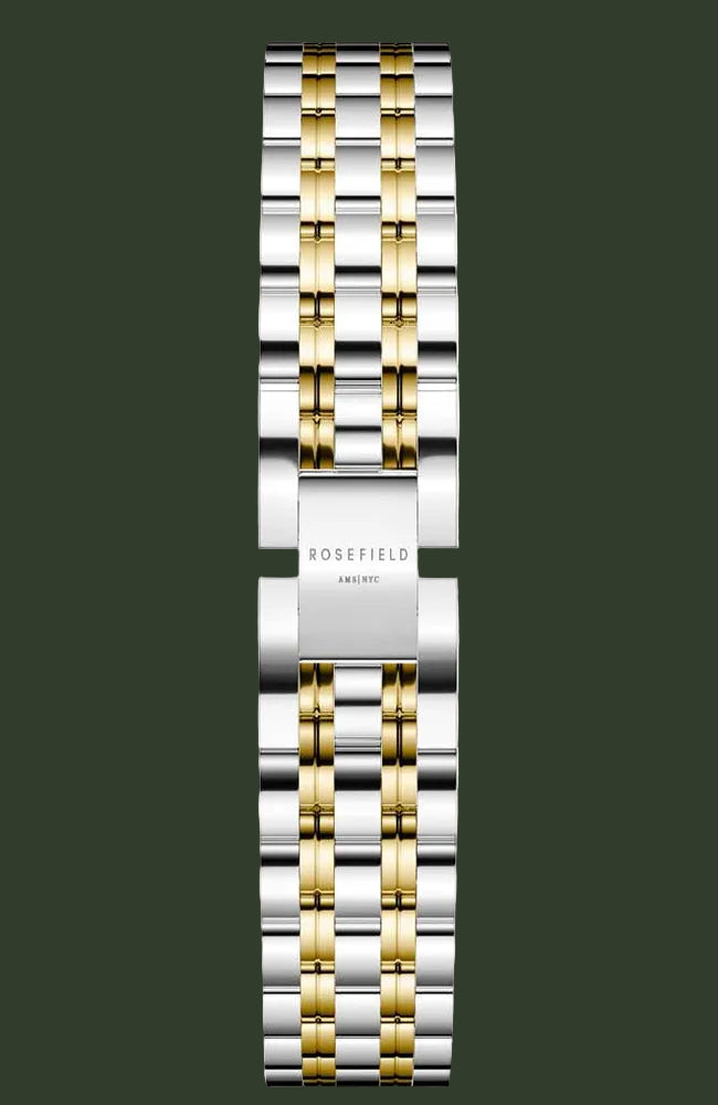 A two-tone stainless steel and gold watch band with a polished finish, featuring the ROSEFIELD brand name engraved on the central clasp, set against a light beige background.