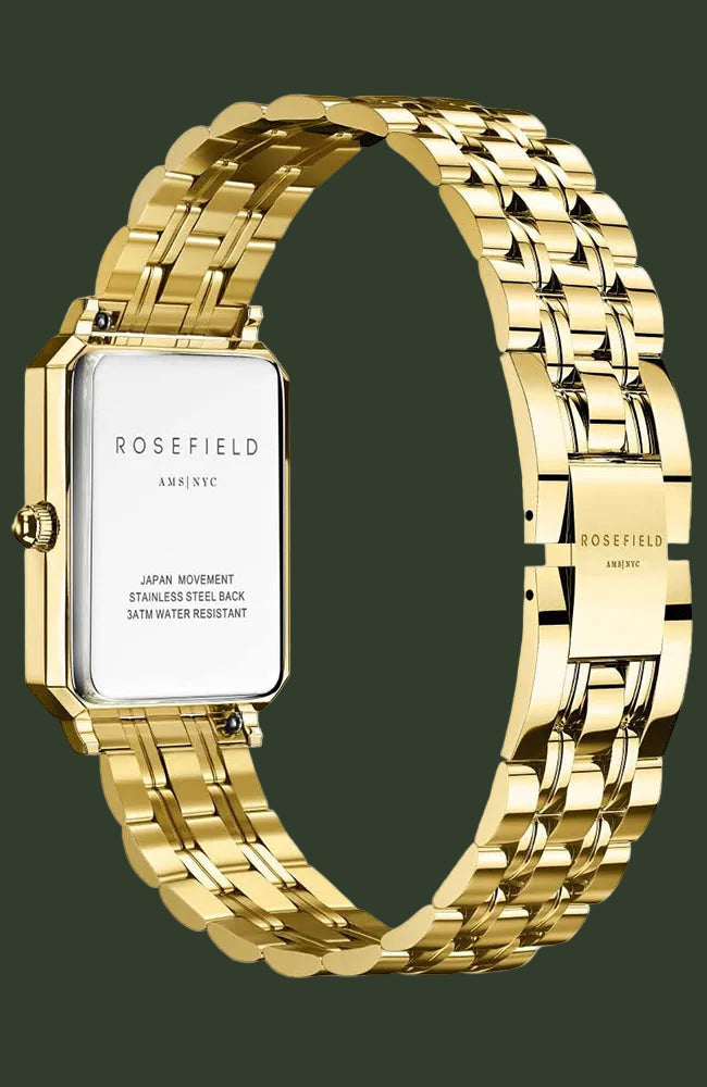 Rosefield Astyc watch with a gold-tone rectangular case and a matching gold-tone link bracelet, shown on a light cream background.