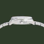 Close-up side view of a silver stainless steel watch with a matching metal link bracelet, featuring a polished case and crown, set against a plain white background.