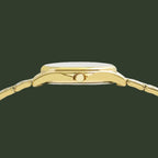 Close-up rear view of a gold-tone watch with a matching metal link bracelet and a single crown button, shown on a plain white background.