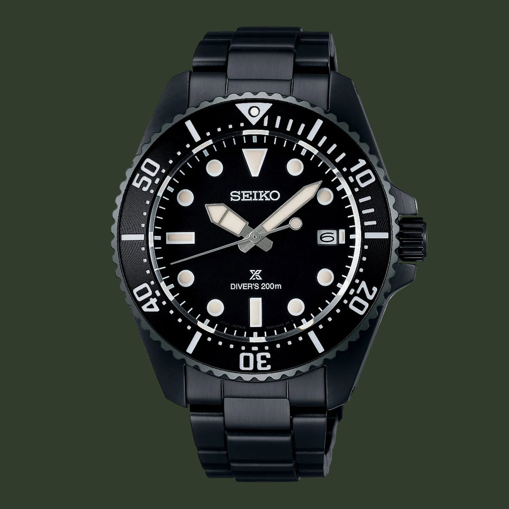 A Seiko Diver's 200m watch with a black resin case and integrated link bracelet, featuring a black dial with white luminous markers and hands.