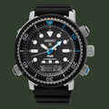 A Seiko x Padi Diverse 300 dive watch with a black dial, black bezel, and black rubber strap, featuring silver-tone case details and blue accents on the hands and bezel.