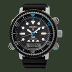 A Seiko x Padi Diverse 300 dive watch with a black dial, black bezel, and black rubber strap, featuring silver-tone case details and blue accents on the hands and bezel.
