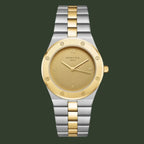 Two-tone watch with gold and silver band on a light gray background