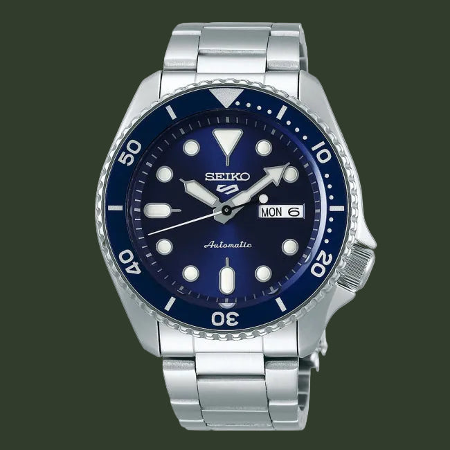 Seiko watch with blue dial and silver metal bracelet on a white background
