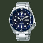 Seiko watch with blue dial and silver metal bracelet on a white background