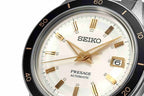 Seiko Presage watch with a white face and gold accents on a white background