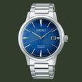 Seiko watch with blue dial and silver metal strap on a white background