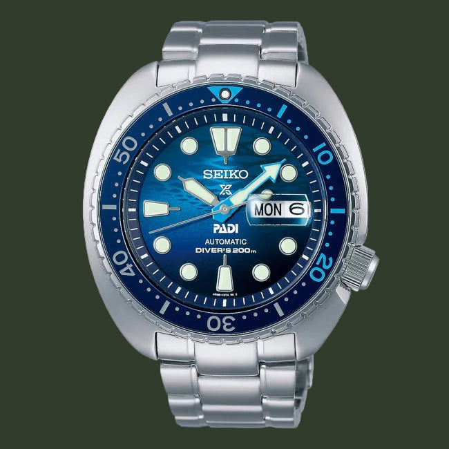 Seiko watch with blue dial and silver metal strap on a white background