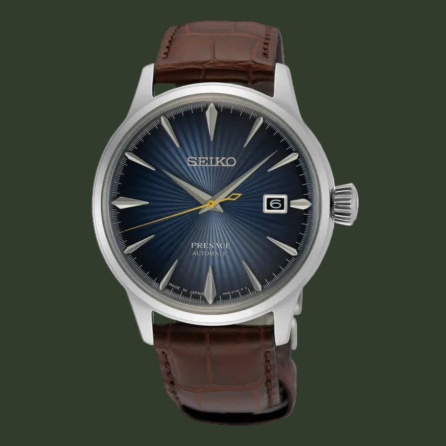 Seiko watch with brown leather strap and blue dial on a white background