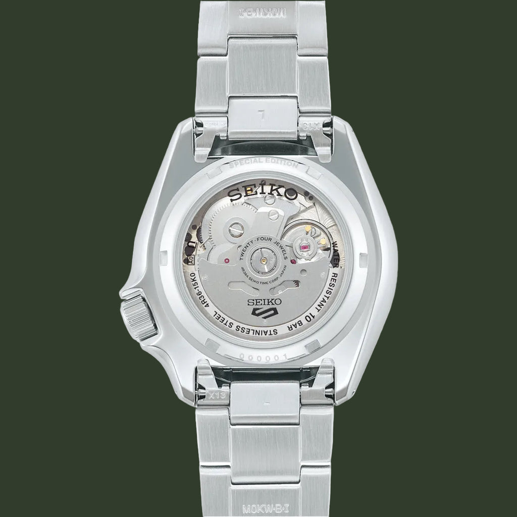 Silver Seiko watch with mechanical components on a white background