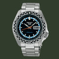 A Seiko automatic watch with a stainless steel link bracelet, featuring a black dial, a black and white checkered bezel, and light blue hour markers.