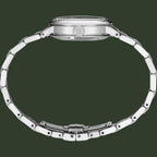 Close-up of a silver watch with a detailed band on a white background