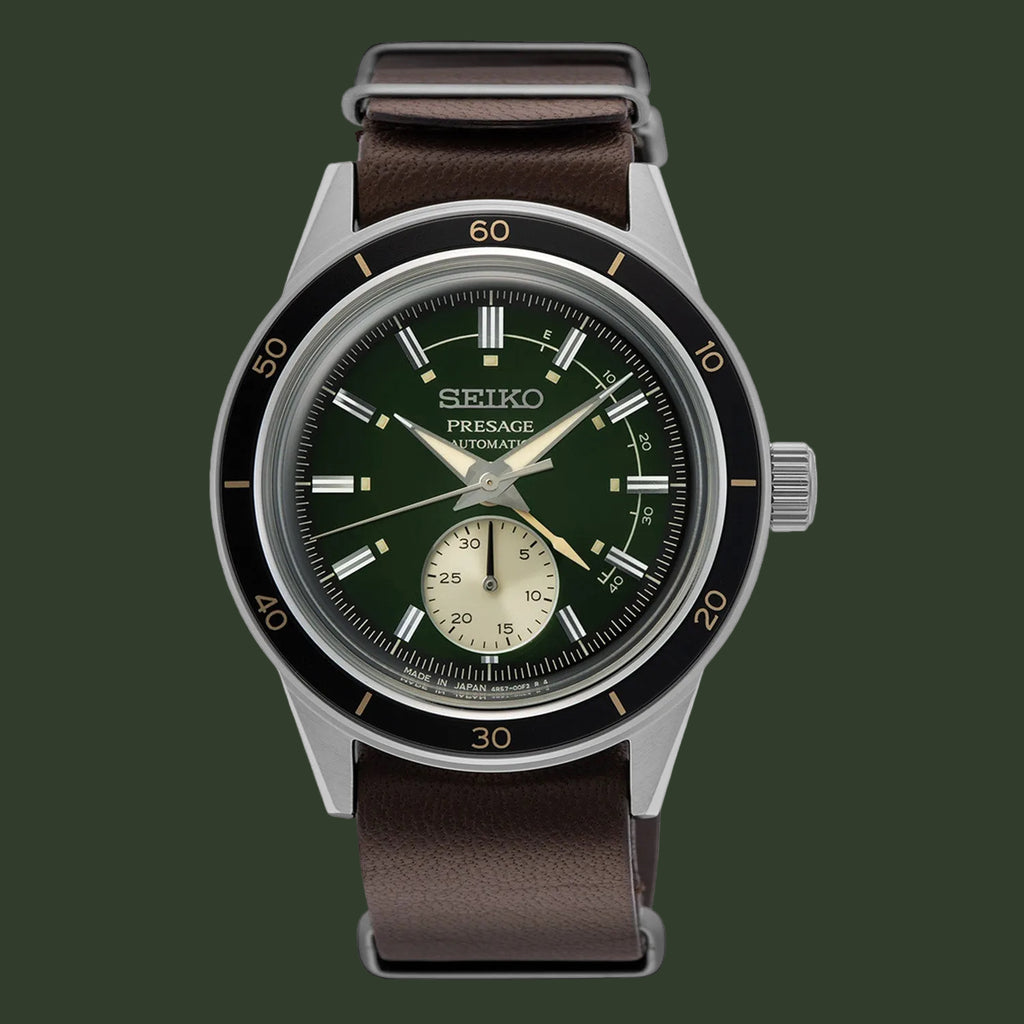 A Seiko Presage automatic watch with a dark green dial, black bezel, silver-toned case, and a brown leather strap, shown against a plain white background.
