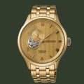 Gold Seiko watch with detailed face on a white background