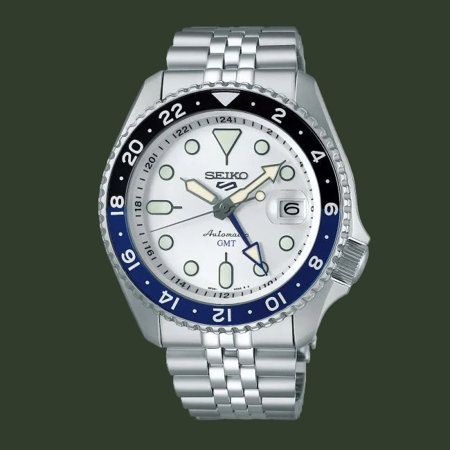 Seiko watch with silver metal bracelet and blue bezel on a white background