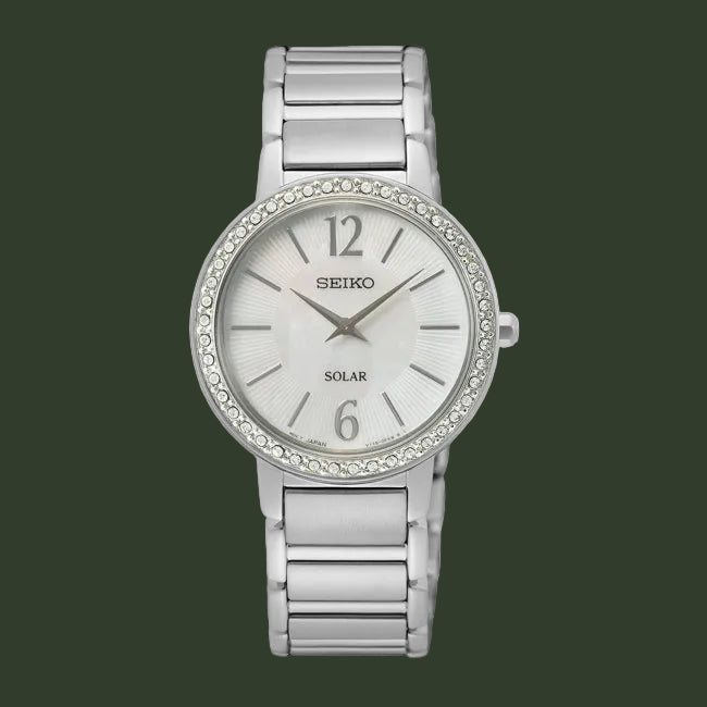 Silver Seiko watch with crystal bezel on a white background